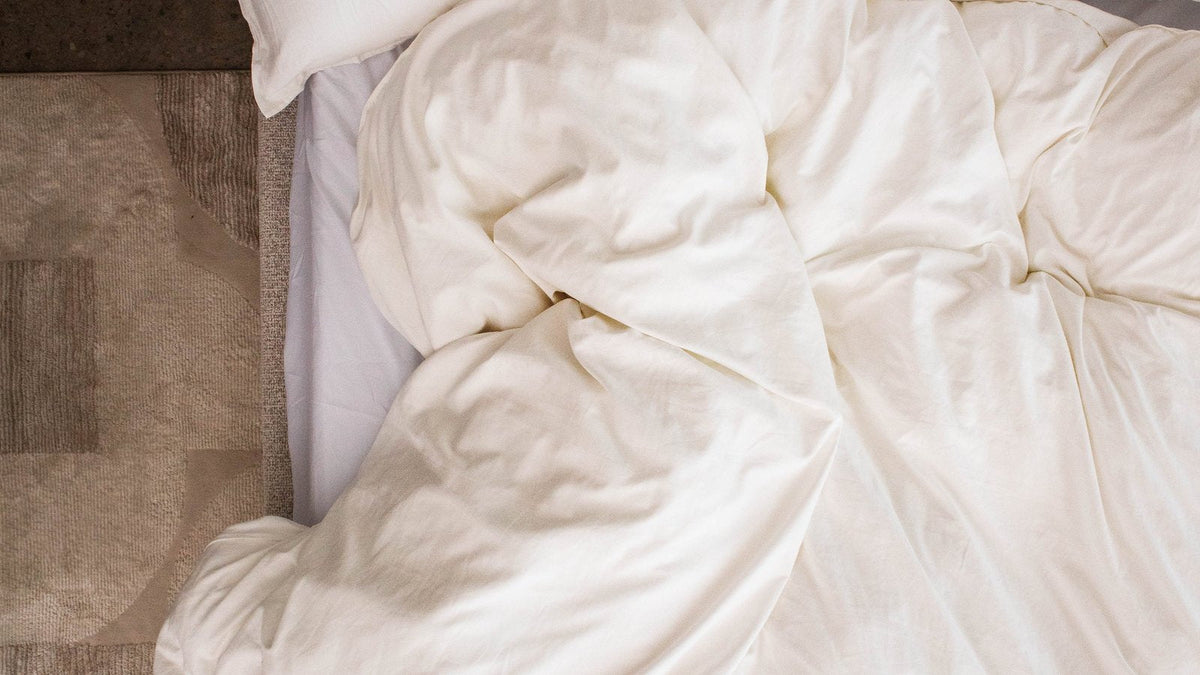 Overhead view of a fluffy cloud duvet and pillows on a bed