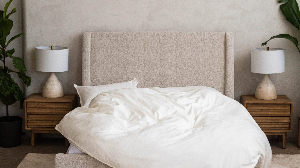 Fluffy white cloud duvet draped loosely over a bed, front view
