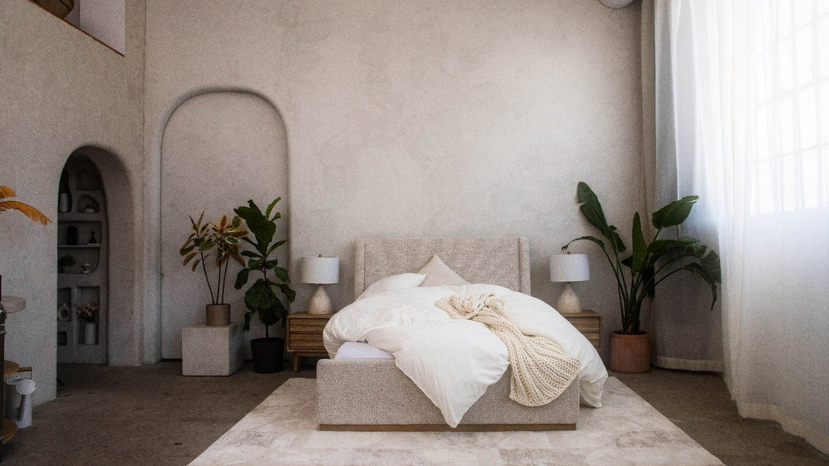 Wide shot of a bedroom with the PureFlow Duvet Heaven Set on the bed and plants either side