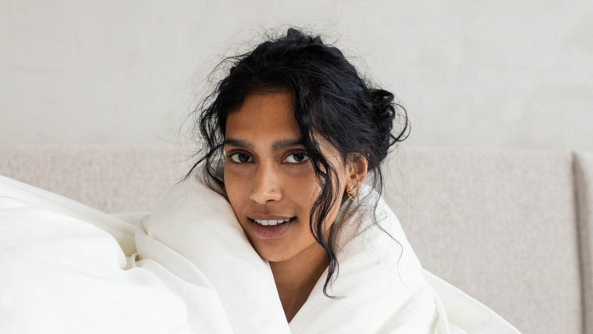 Woman hugging a fluffy feather free down alternative duvet
