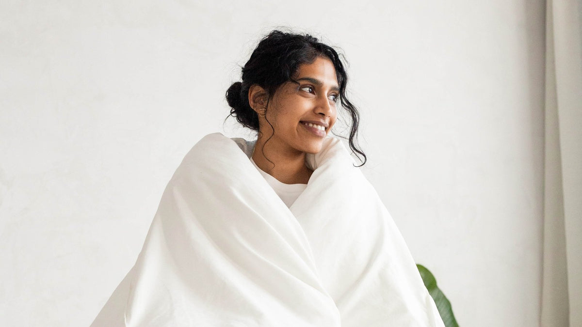 Woman standing wrapped in the PureFlow cloud duvet