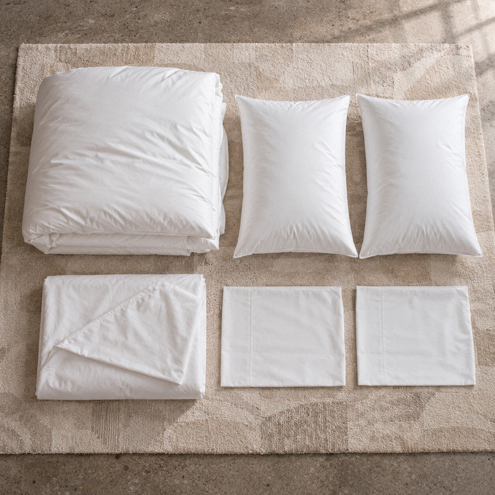The pieces of a PureFlow set laid out: duvet, cover, pillows and pillowcases