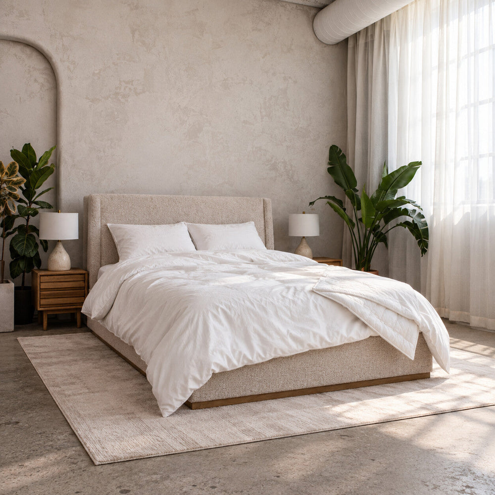 Air Duvet Set made up on an upholstered bed in a sunlit bedroom, the lightweight duvet in its white cotton cover