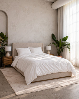 Air Duvet Set on a bed in a bright bedroom with arched walls, nightstands and plants