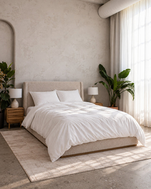 Air Duvet Set on a bed in a bright bedroom with arched walls, nightstands and plants