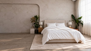 Wide view of a bedroom with the Air Duvet Set on the bed beside a tall window