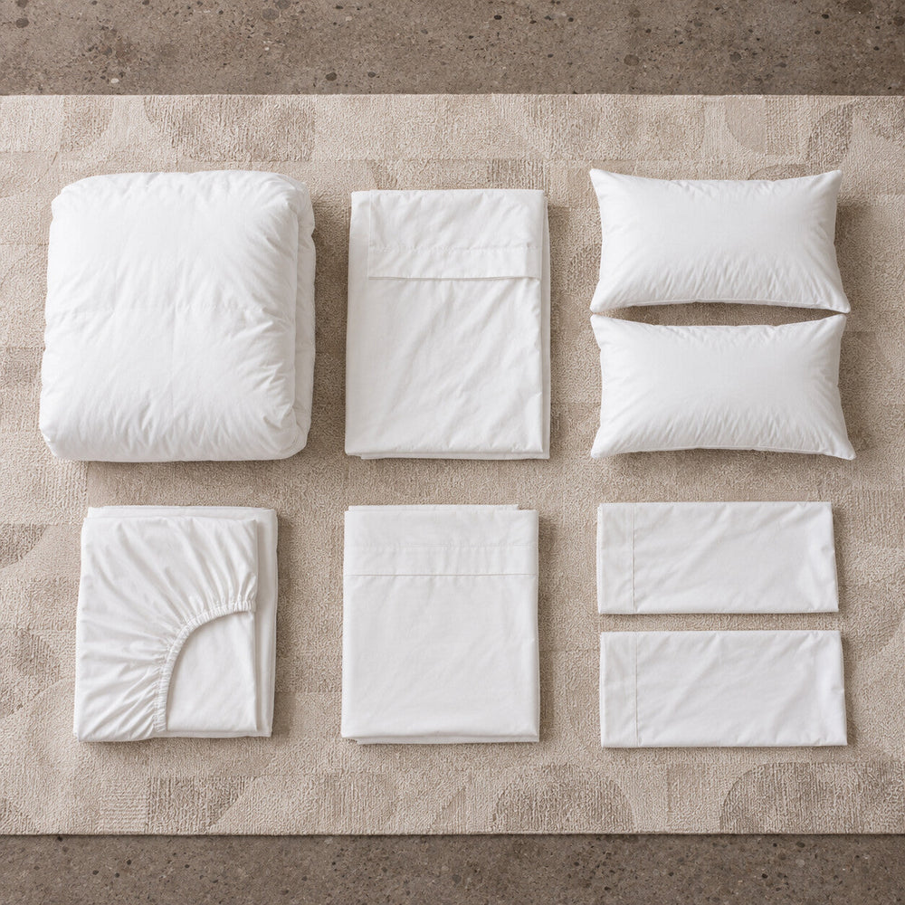 The Full Cloud Bed Set made up on a bed, sheets, duvet and pillows