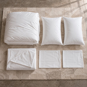 All six pieces laid out: the duvet, its cover, two pillows and two pillowcases
