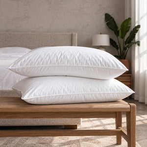 The two Cloud Pillows included in the Cloud Sleep Set, stacked on a wooden bench