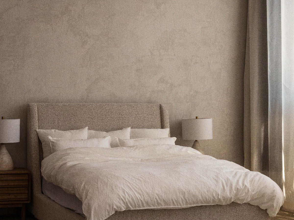 Bed made with a thin, flat comforter