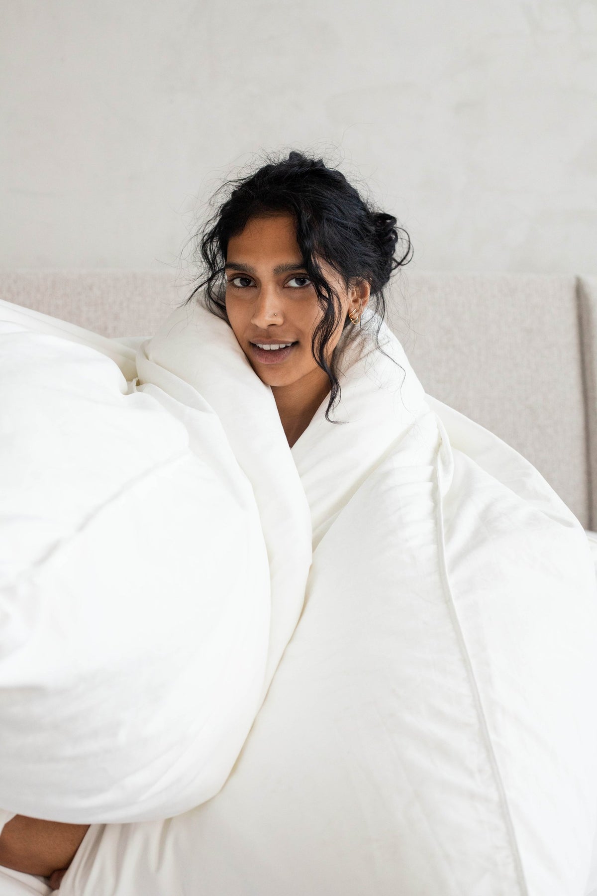 Woman hugging a fluffy feather free down alternative duvet