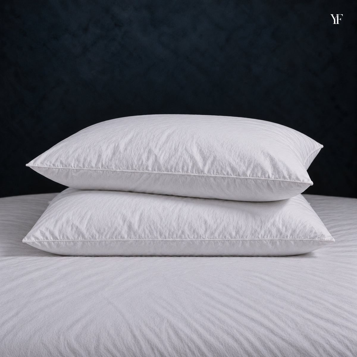 Two filled white Cloud pillows stacked on a bed.