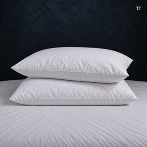 Two Cloud Pillows stacked on a made bed, showing their full, even height