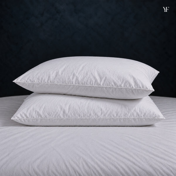Two Cloud Pillows stacked on a made bed, showing their full, even height