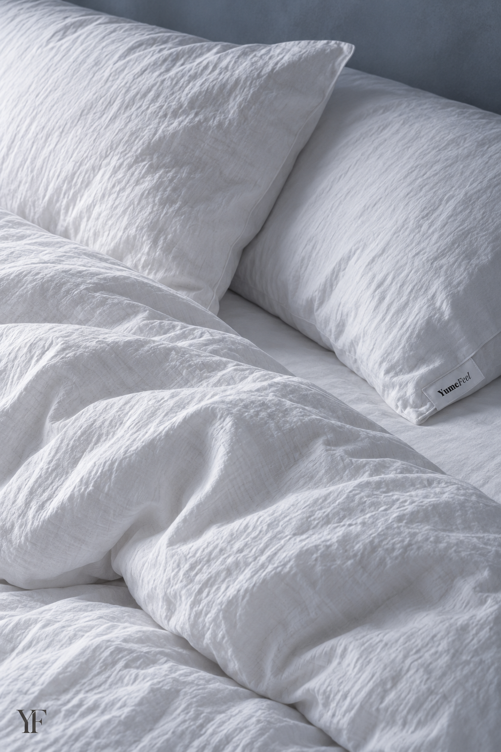 Two white pillows above the draped Royal duvet on a bed.