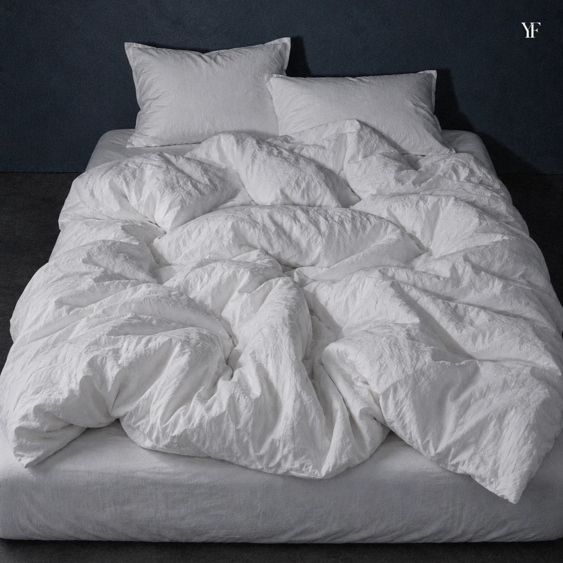 Air duvet on a made bed.